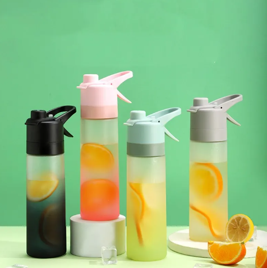 Misting sports water bottle with spray function